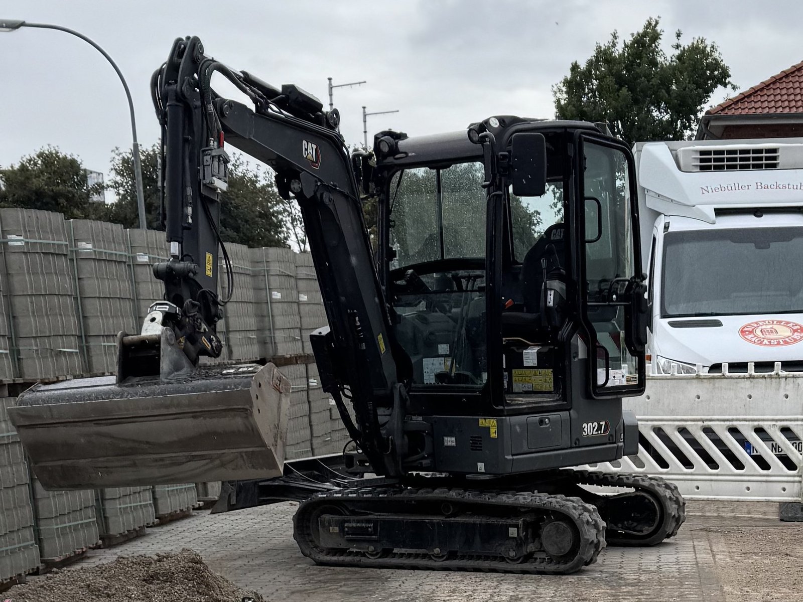 CAT 302.7 Minibagger auf einer gepflasterten Baustelle